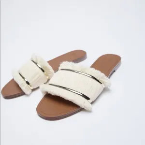 FRINGED FLAT SANDALS