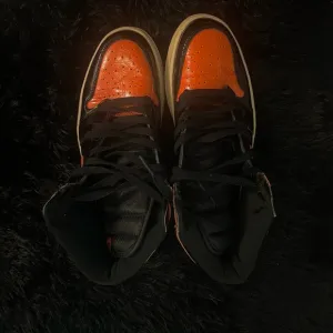Jordan’s Orange and Black High-Top Sneakers