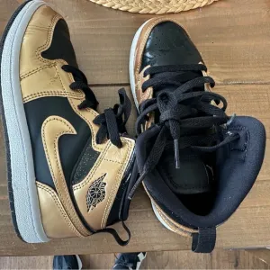 Nike Black and Gold High-Top Sneakers with Leather Finish
