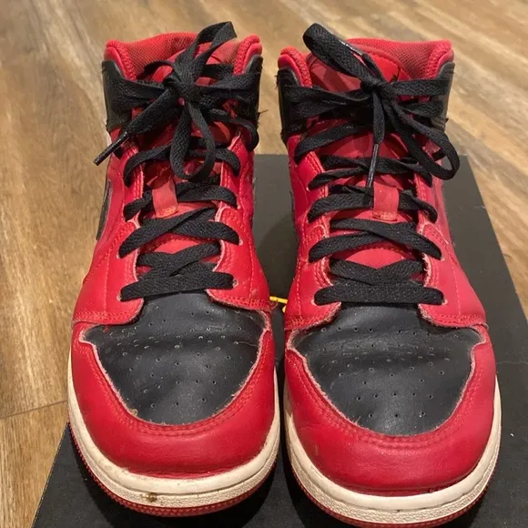 Youth red and black Nike Air Jordan high top sneakers